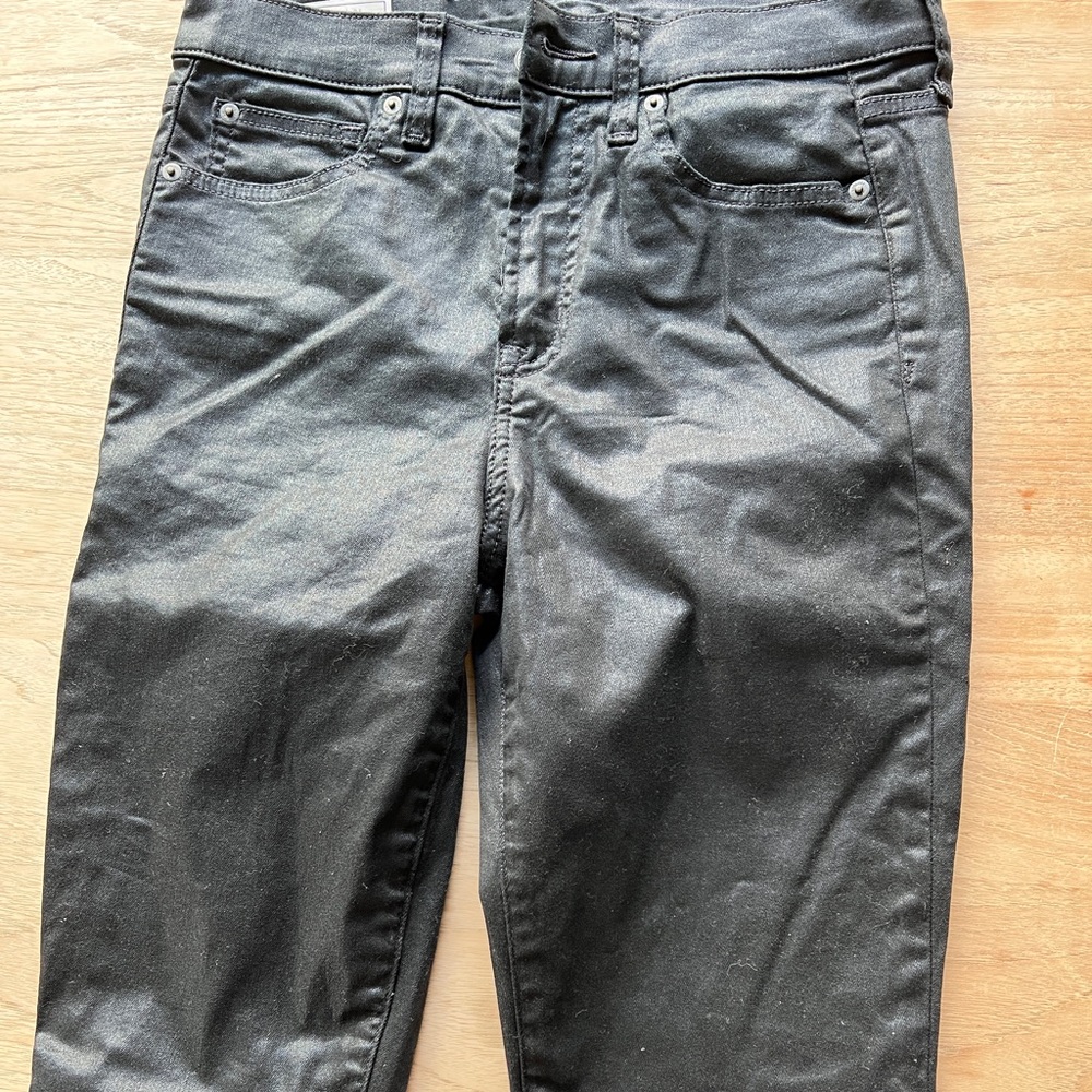 Black coated - looks like leather jeans.  never been worn!